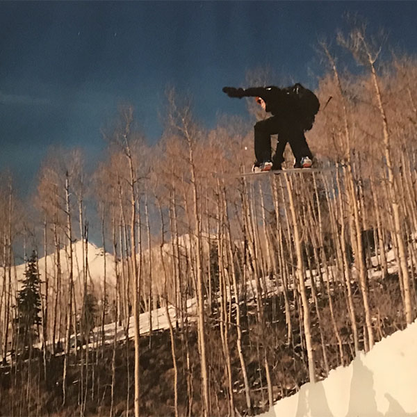 teenage nick flying off a snowboard jump